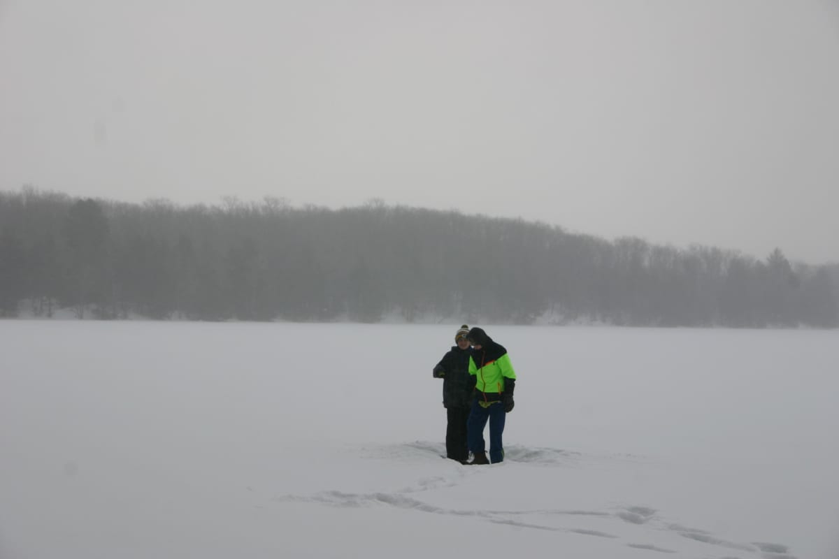 Sam and Kyle  choosing Charlie's spot to sit  on the ice.